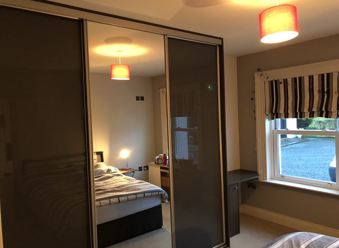 dark grey bedroom with mirrored sliderobe