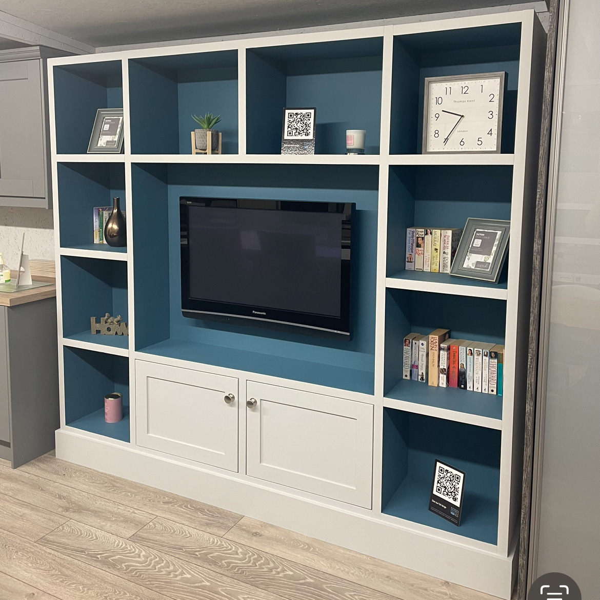 Blue and white media wall for storing books and decor